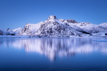 Fototapeta na wymiar Mountain ridge and reflection in the lake. Natural landscape in the Norway