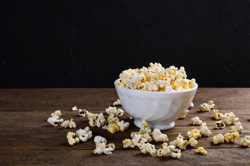 Air salty popcorn.A bowl of popcorn on a wooden table.Salt popcorn on the wooden background .  With space for text.Top view.popcorn texture.Chees .