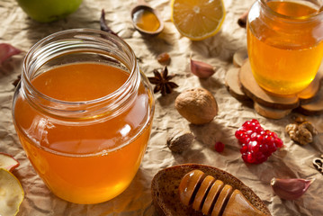 glass jar of honey on paper