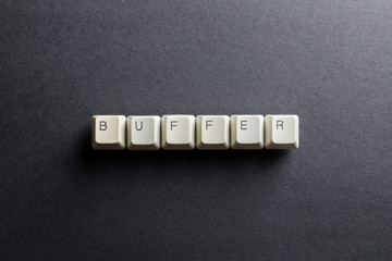 Word buffer made using computer keyboard buttons on a black background. Compact disk. IT technology concept.
