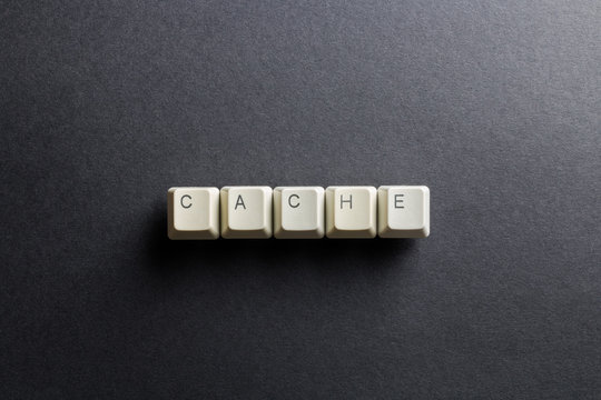 Word cache made using computer keyboard buttons on a black background. Compact disk. IT technology concept.