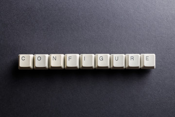 Word configure made using computer keyboard buttons on a black background. IT technology concept.