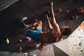 Foto op Plexiglas Man climbing indoor boulder wall © Jacob Lund