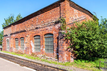 Fototapeta na wymiar Old depot of red brick at the provincial railway station