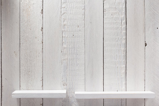 white shelf on wooden wall