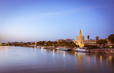 Blue Hour view of Golden tower or Torre del Oro, along the Guadalquivir river, Seville, Spain.