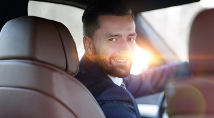 Close-up of a businessman sitting at the wheel of a car