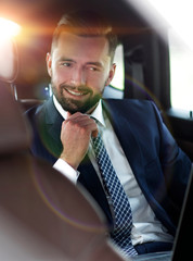 Close-up of a successful businessman sitting in a comfortable car