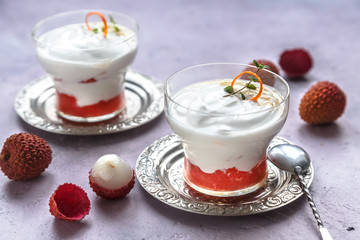 Lychee dessert with grapefruit on pink background