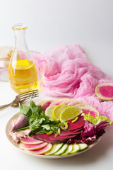 Fresh salad with beets, watermelon radish, cucumber, parsley, lime, garlic, olive oil, mix salads. Pink vegetables Healthy concept.Vegan food. White background.