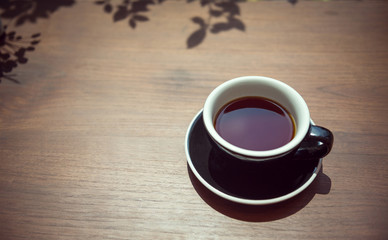 Coffee cup on wooden table from top ,vintage tone