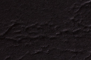 Black crumpled paper texture.