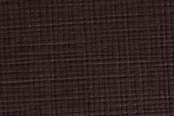 Fototapeta premium Brown checked paper texture background, macro shot.