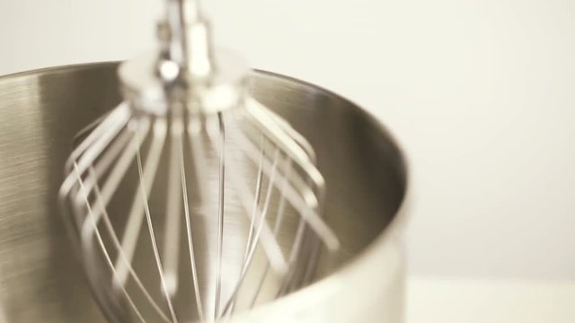 Close up of silver food electric mixer on a white background