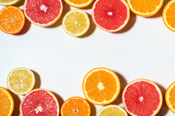 Assorted sliced fruits on white background.  Flat lay. Food vegan concept.