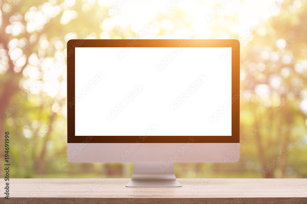 Poster modern desktop computer on wooden table and abstract light blur and bokeh background. saved with cli