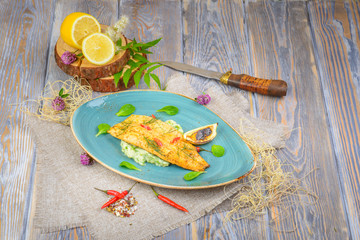 fried fish on a wooden background