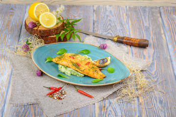 fried fish on a wooden background