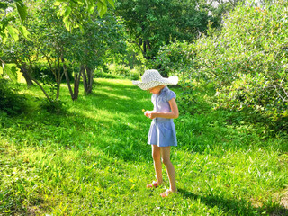 Adorable little girl in a summer park.