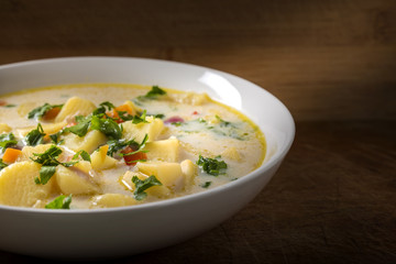 Homemade potato soup with sour cream and vegetables