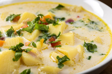 Romanian Homemade potato soup with sour cream and vegetables
