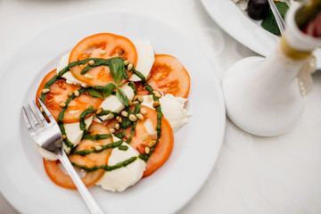 Caprese salad made of mozzarella cheese, tomatoes and basil