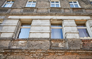 Fototapeta na wymiar Bullet holes from the World War II in an apartment building in Niebuszewo district in Szczecin City, Poland.