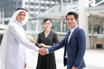 Confident and Active Businessmen Making Handshake Outdoor. Looking to Camera.