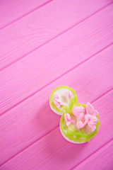 Decorative figure eight on pink wooden background