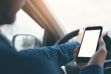 Man using smartphone inside a car