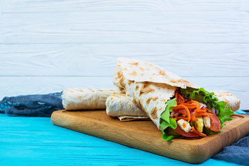 Delicious shawarma sandwich on wooden background