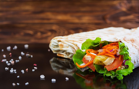 Delicious shawarma sandwich on wooden background