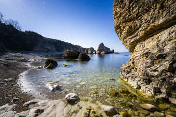 Fototapeta na wymiar long exposure shot on sea with rocks