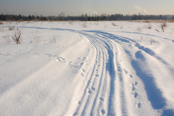Sunny winter day in the countryside. The sign of winter-icicles