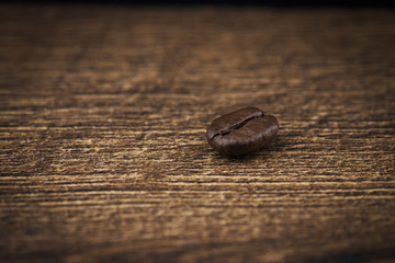 Coffee beans on a wooden background close-up.