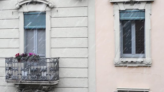 abundant snowfall in a cold winter whitens the roofs of the city facades and windows and trees are covered by an immaculate blanket