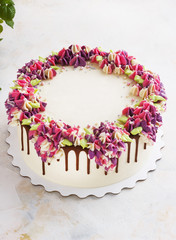 Festive cake with cream flowers hydrangea on a light background