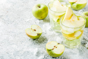 Sour Apple Cocktail or Infused detox water, cold summer drink. on grey stone table copy space
