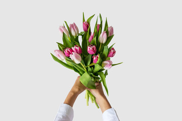 Bouquet of tulips in beautiful woman's hands.