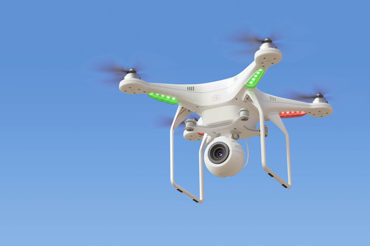 Quadcopter drone with camera in blue sky
