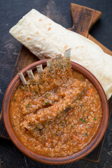 Bowl of georgian traditional kharcho soup with lamb meat and rice, vertical shot, top view