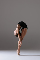 Young gymnast girl stretching and training