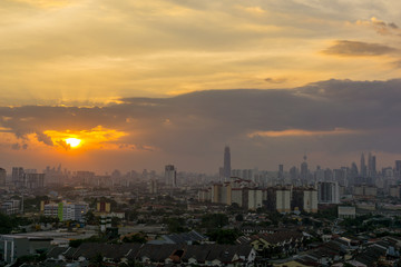 Fototapeta premium View of sunset at downtown Kuala Lumpur. Its modern skyline is dominated by the 451m tall Petronas Twin Towers, pair of of glass-and-steel-clad skyscraper.