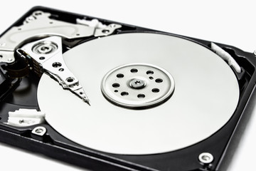 Inside a hard drive with a data plate and a needle for reading and writing data.
