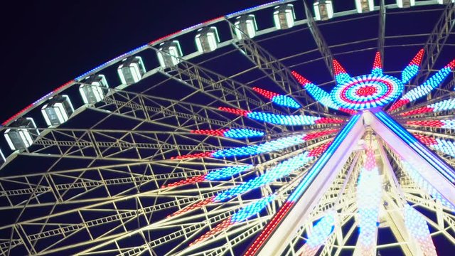 Big Wheel decorated and illuminated with Christmas lights, amusement park symbol