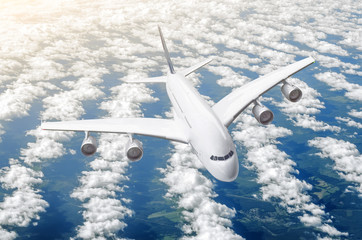 Naklejka na ściany i meble Passenger huge liner plane fly on a fly above clouds and blue sky.