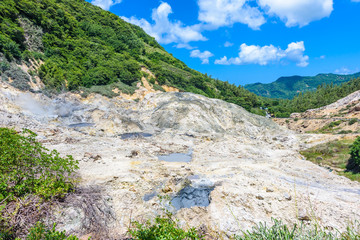 Fototapeta na wymiar View of Drive-In Volcano Sulphur Springs on the Caribbean island of St. Lucia. La Soufriere Volcano is the only drive-in volcano in the world.