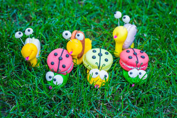 Little cheerful snails and ladybugs in the form of sweets and cookies