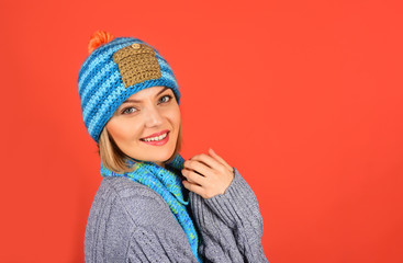 Beautiful attractive woman dressed in warm sweater, hat and scarf. Glamorous fashion portrait of beautiful charming girl in winter clothes. Winter concept. Copy space to advertise the clothing store.