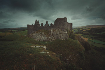 Fototapeta na wymiar Carreg Cennen castle and cloudy sky